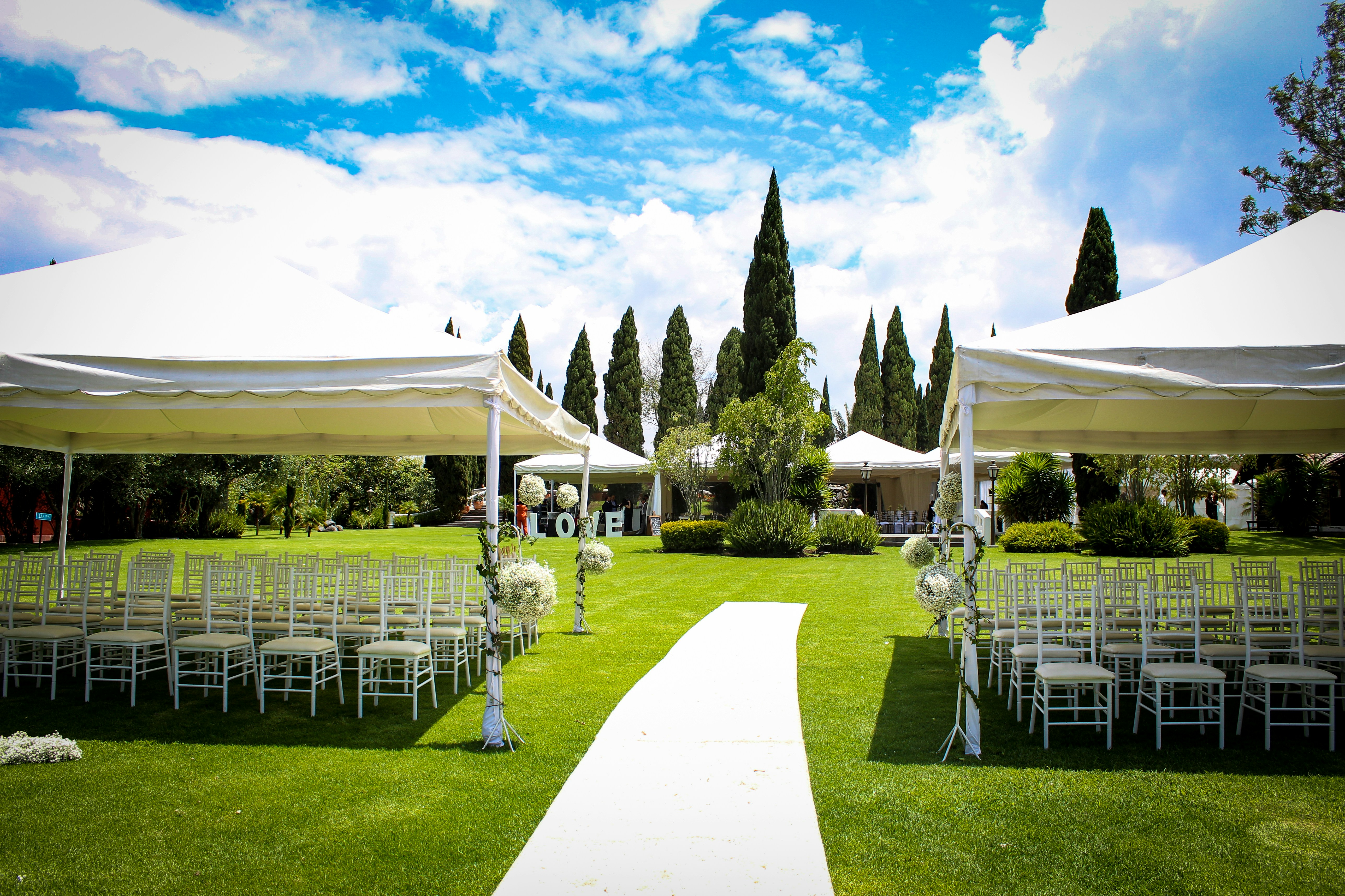 Premium tailored marquee staging layout inside an expansive canopy